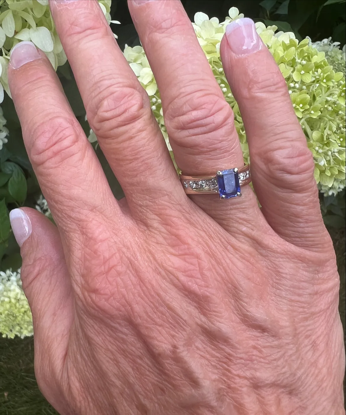 Emerald-cut blue sapphire ring with channel-set diamonds